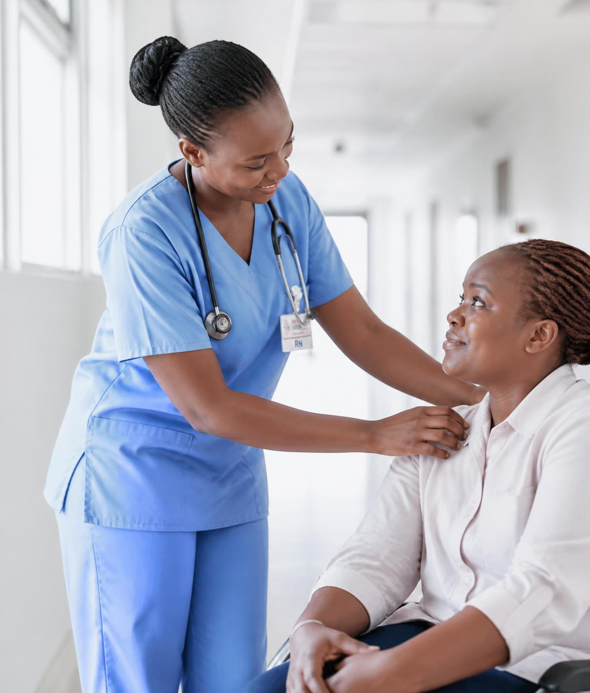 A nurse at Sheywe Community Hospital caring for a seated patient