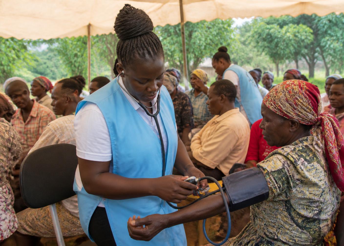 Health workers supporting community members at an outreach activity